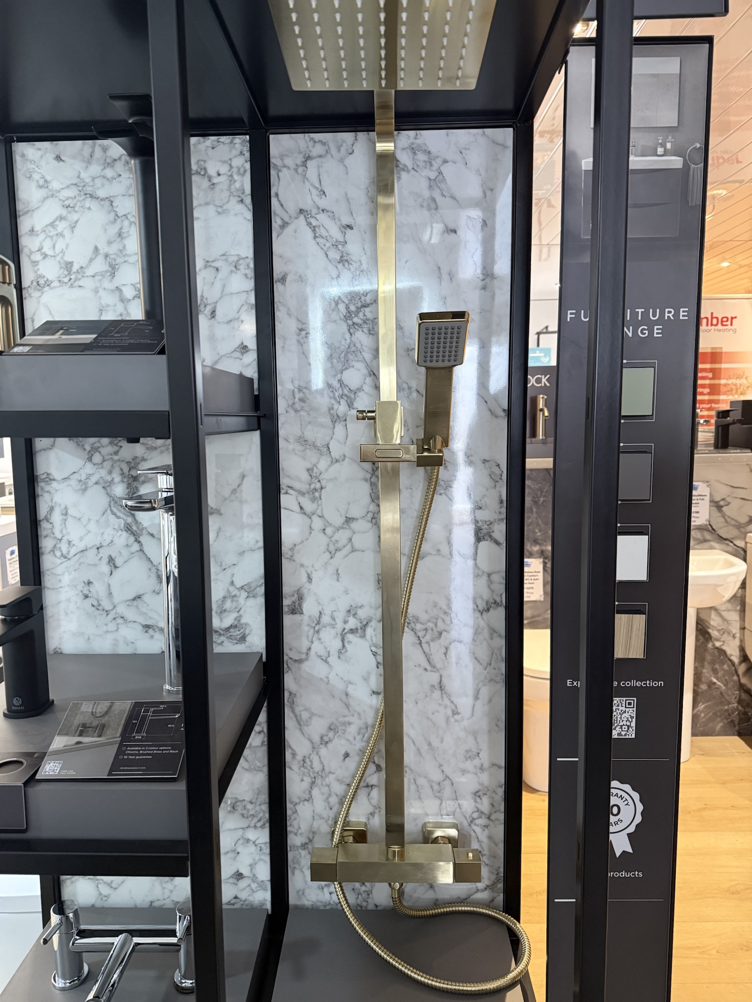 Close up of Swan brass shower on the display stand
